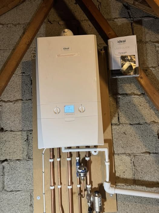 Luke fitting a new boiler in a loft space